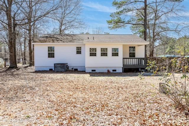 rear view of property with central AC unit, fence, roof with shingles, crawl space, and a wooden deck