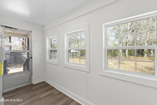 entryway featuring dark wood finished floors and baseboards