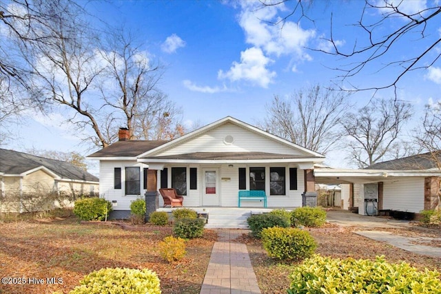 view of front of property featuring a carport and covered porch