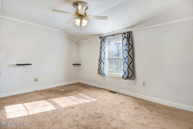 carpeted spare room featuring crown molding, ceiling fan, and lofted ceiling