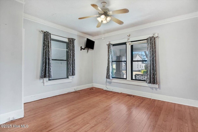 spare room featuring crown molding, ceiling fan, and hardwood / wood-style floors