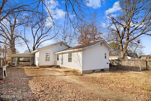 rear view of property featuring a carport