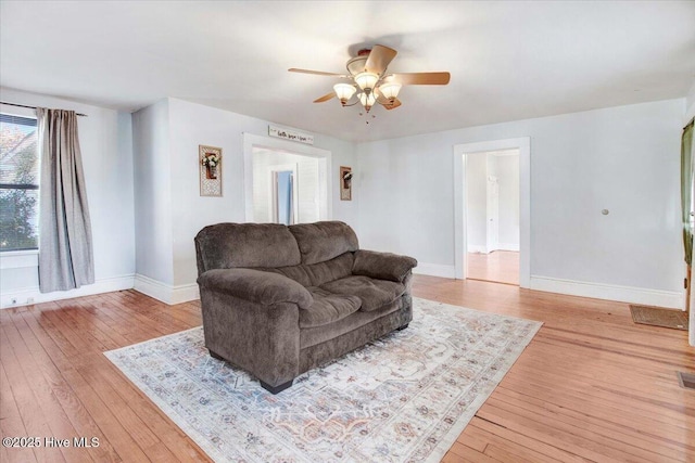 living room featuring ceiling fan and light wood-type flooring