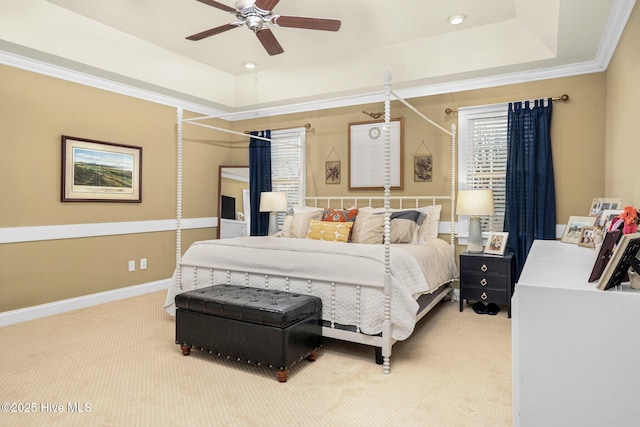 carpeted bedroom featuring a raised ceiling, crown molding, and ceiling fan