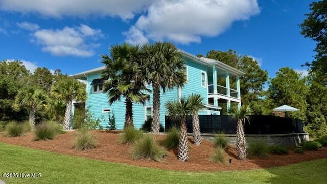 view of side of home featuring a balcony