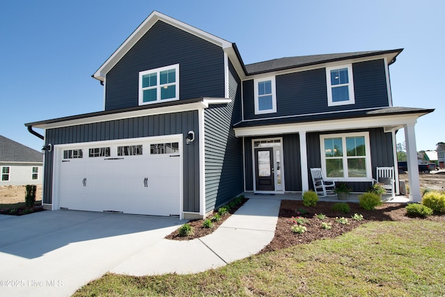 view of front facade featuring a garage, a front yard, and covered porch