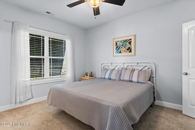 134 NE 11th St, Oak Island, NC 28465 - carpeted bedroom featuring baseboards and a ceiling fan