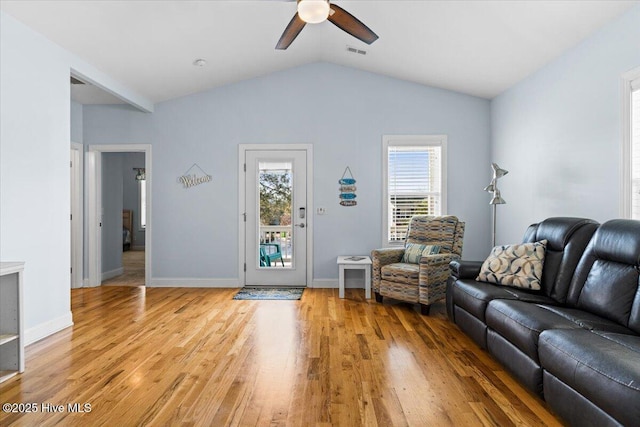 unfurnished living room featuring baseboards, visible vents, lofted ceiling, light wood-style flooring, and ceiling fan