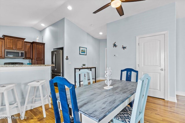 dining room featuring lofted ceiling, light wood-style flooring, a ceiling fan, recessed lighting, and baseboards