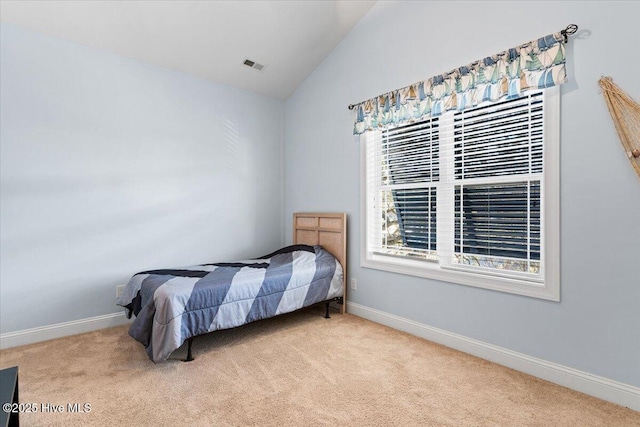 bedroom featuring baseboards, carpet floors, and lofted ceiling