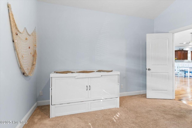 unfurnished bedroom featuring baseboards and carpet