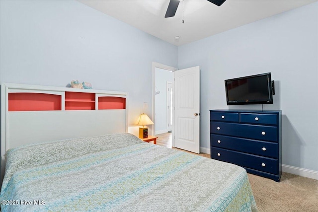 carpeted bedroom with ceiling fan and baseboards