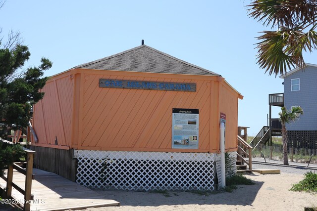 134 NE 11th St, Oak Island, NC 28465 - view of property exterior featuring stairs and a shingled roof