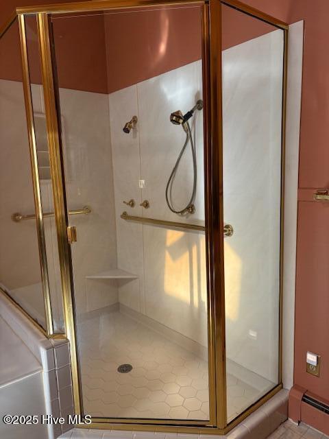 bathroom with a baseboard radiator and a shower with door