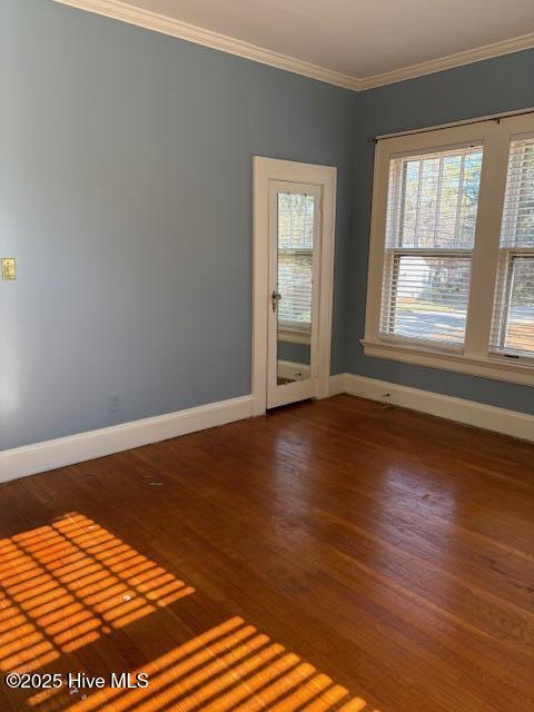 unfurnished room with dark wood-type flooring and ornamental molding