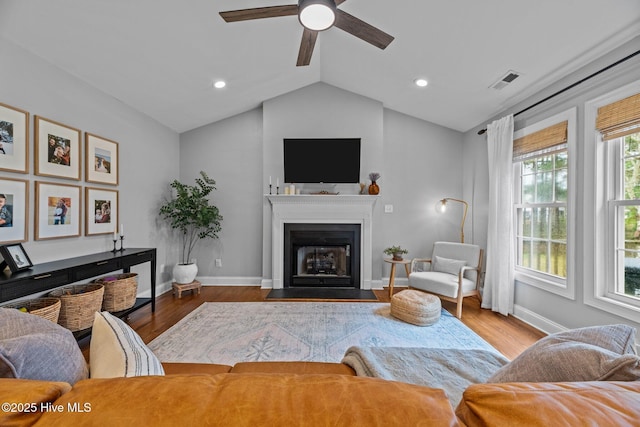 living room with vaulted ceiling, ceiling fan, and hardwood / wood-style floors