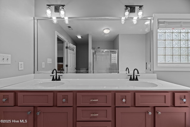 bathroom with walk in shower and vanity