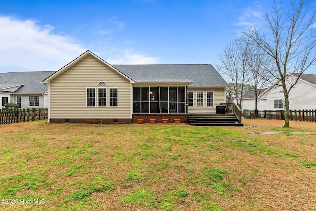 rear view of property featuring a wooden deck, a sunroom, and a yard