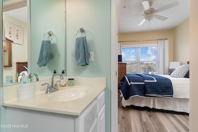 bathroom with hardwood / wood-style flooring, vanity, and ceiling fan