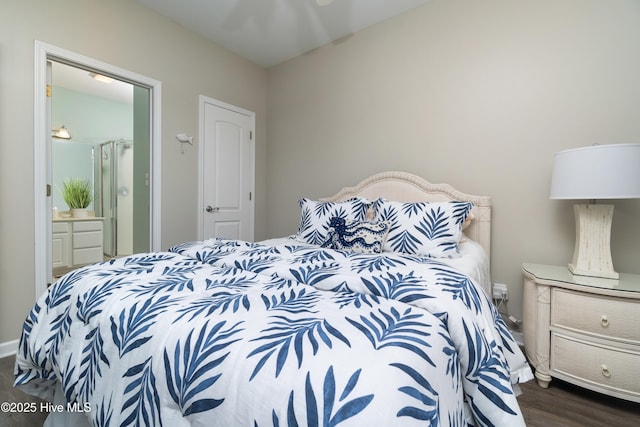 bedroom featuring dark wood-type flooring and connected bathroom