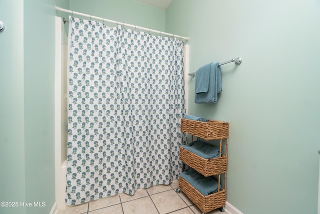 bathroom with shower / tub combo with curtain and tile patterned floors