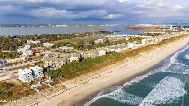 drone / aerial view with a water view and a beach view