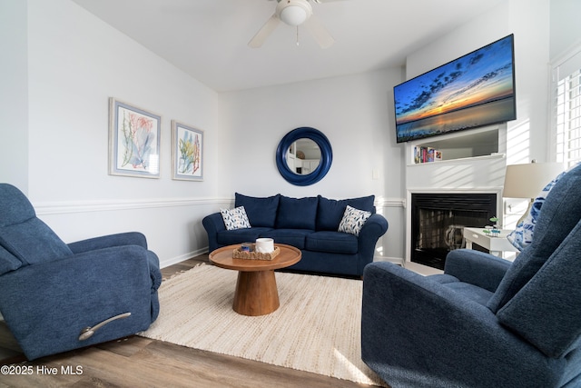 living room featuring dark hardwood / wood-style floors and ceiling fan