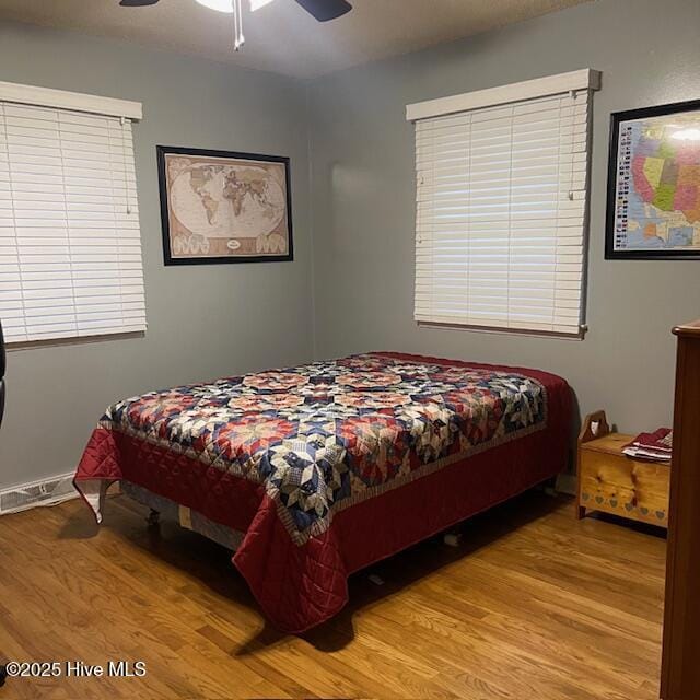 bedroom with ceiling fan and light wood-type flooring