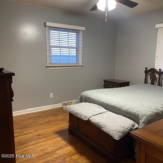 bedroom featuring ceiling fan and hardwood / wood-style floors