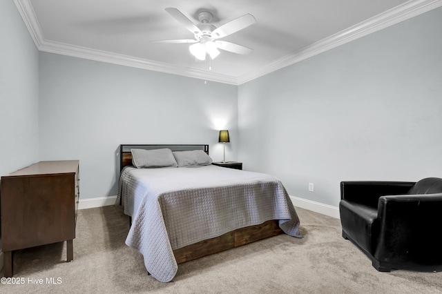 carpeted bedroom featuring crown molding and ceiling fan