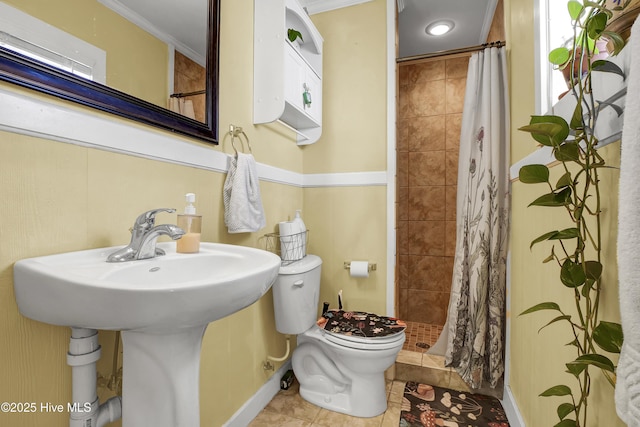 bathroom featuring crown molding, tile patterned floors, toilet, and walk in shower