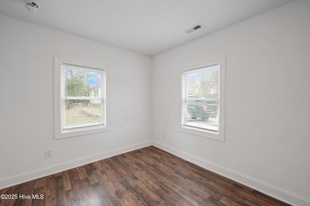 unfurnished room featuring dark wood-type flooring