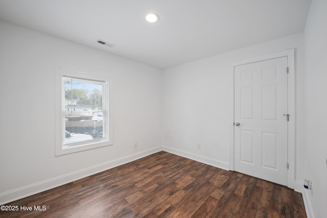 spare room featuring dark hardwood / wood-style flooring