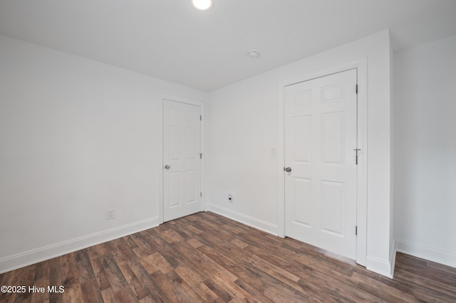 spare room with dark hardwood / wood-style flooring