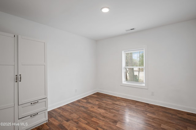 unfurnished bedroom featuring dark wood-type flooring