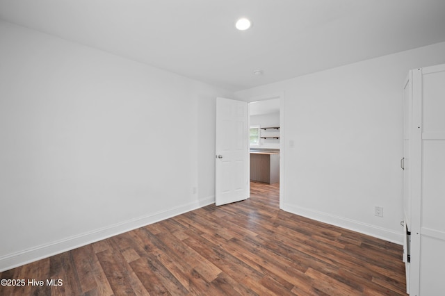 unfurnished bedroom with dark wood-type flooring