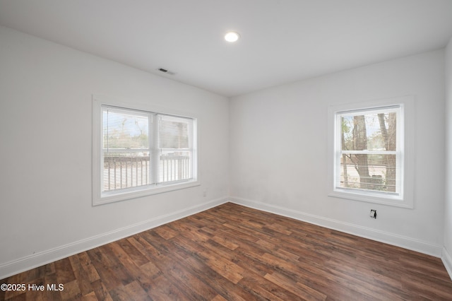 unfurnished room with dark hardwood / wood-style floors