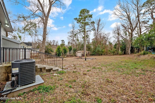 view of yard with a storage unit and central air condition unit