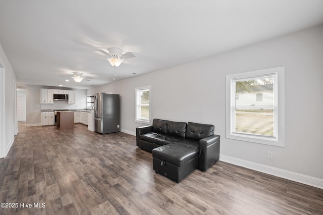 living room featuring hardwood / wood-style floors and ceiling fan