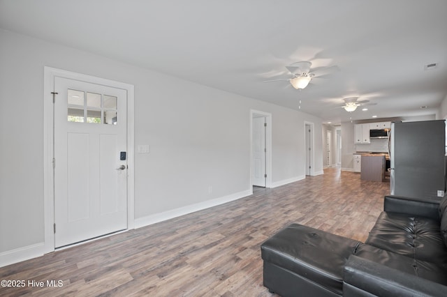 living room with ceiling fan and hardwood / wood-style floors