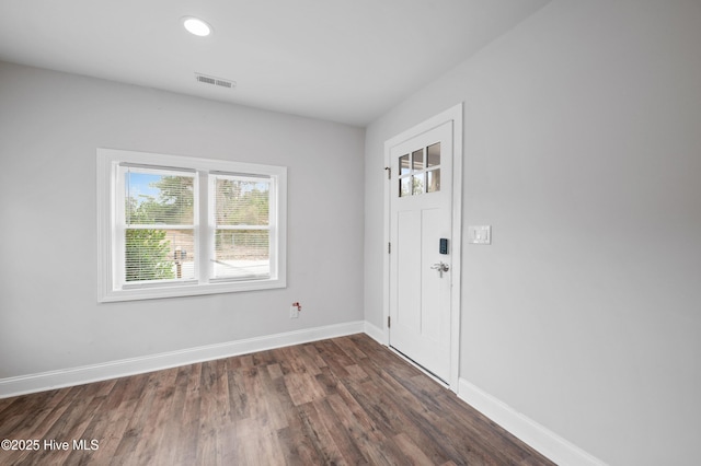 spare room featuring dark hardwood / wood-style flooring