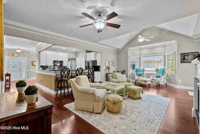 living room featuring lofted ceiling, dark wood-style flooring, crown molding, and baseboards