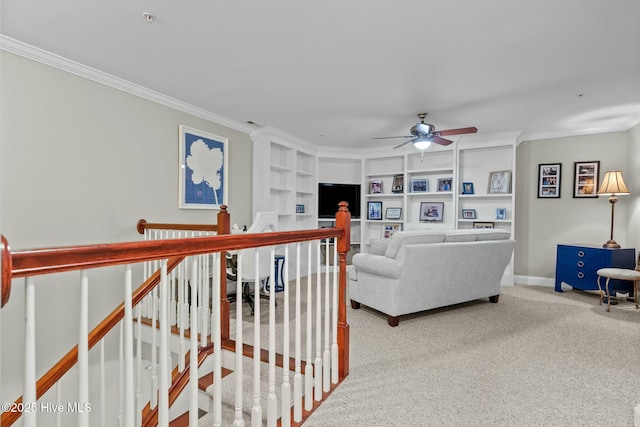 living room with ceiling fan, built in features, baseboards, ornamental molding, and carpet