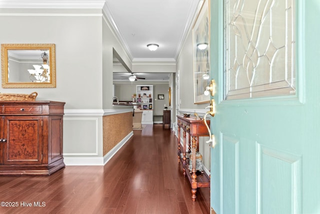 entryway featuring dark wood-style flooring, crown molding, and ceiling fan