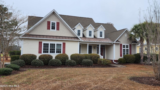 view of front facade with covered porch and a front lawn