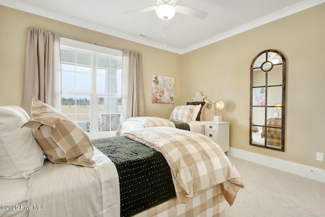 bedroom featuring ceiling fan, ornamental molding, and carpet flooring