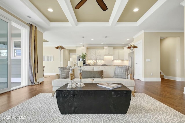 living room featuring dark hardwood / wood-style flooring, coffered ceiling, ceiling fan, crown molding, and beam ceiling