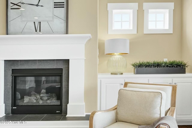 living area featuring a tiled fireplace