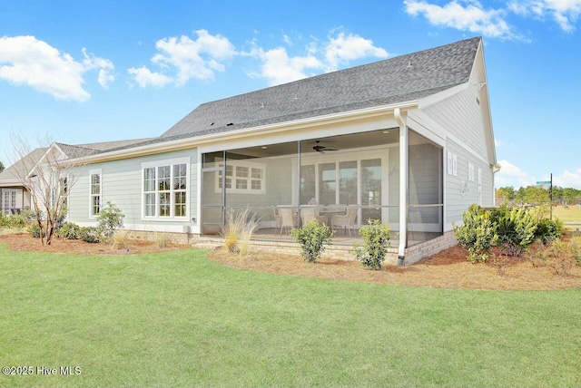 back of property featuring ceiling fan, a sunroom, and a lawn