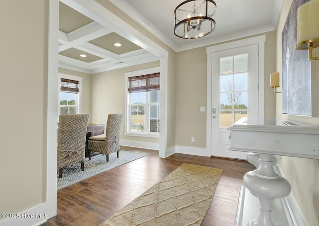 interior space with coffered ceiling, an inviting chandelier, ornamental molding, dark hardwood / wood-style flooring, and beamed ceiling